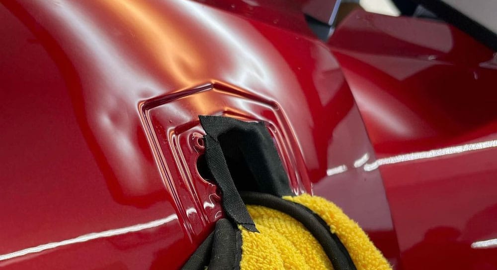 Before paintless dent repair on a Ferrari