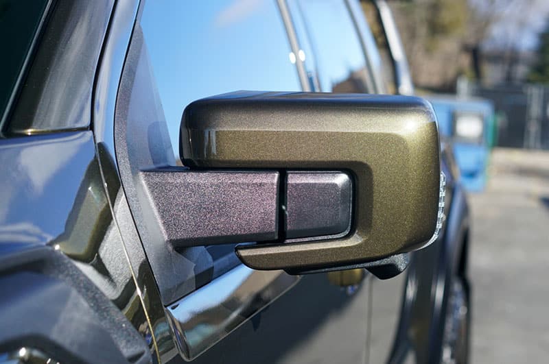 Fresh PPF Install on a 2025 Ford Raptor Green Drivers Side Mirror looking down the Exterior panels