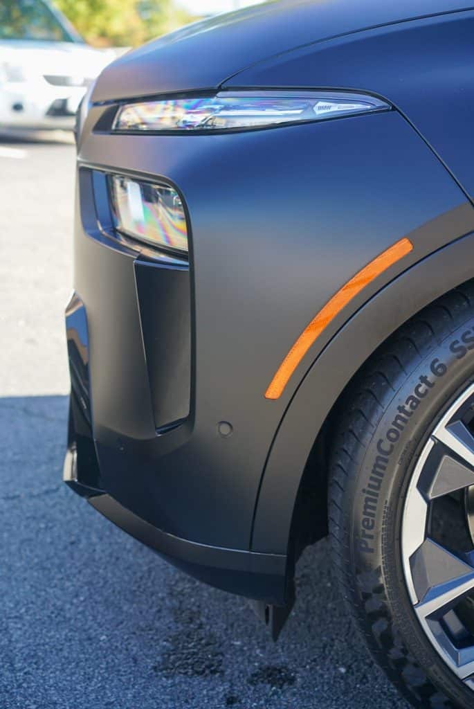 BMW X7 M60i headlight and front fender detail in matte black STEK paint protection film