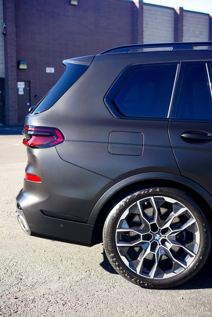 BMW X7 M60i rear quarter panel and M Performance wheel after STEK DYNOmatte Black PPF install